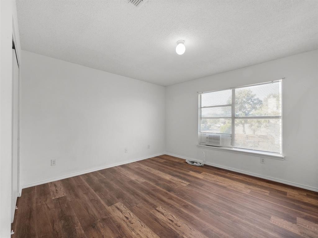 1237 McCary Street Cedar Hill, TX 75104 - Photo 21 of 38 an empty room with wooden floor and windows
