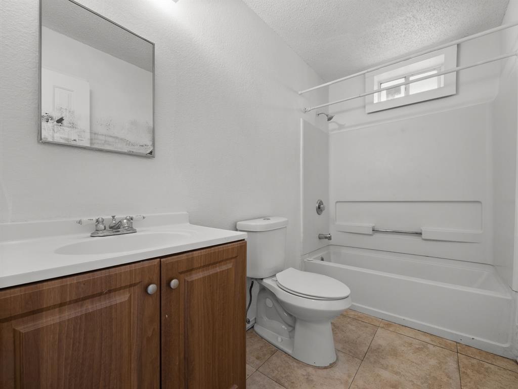 1237 McCary Street Cedar Hill, TX 75104 - Photo 24 of 38 a bathroom with a granite countertop toilet sink and mirror