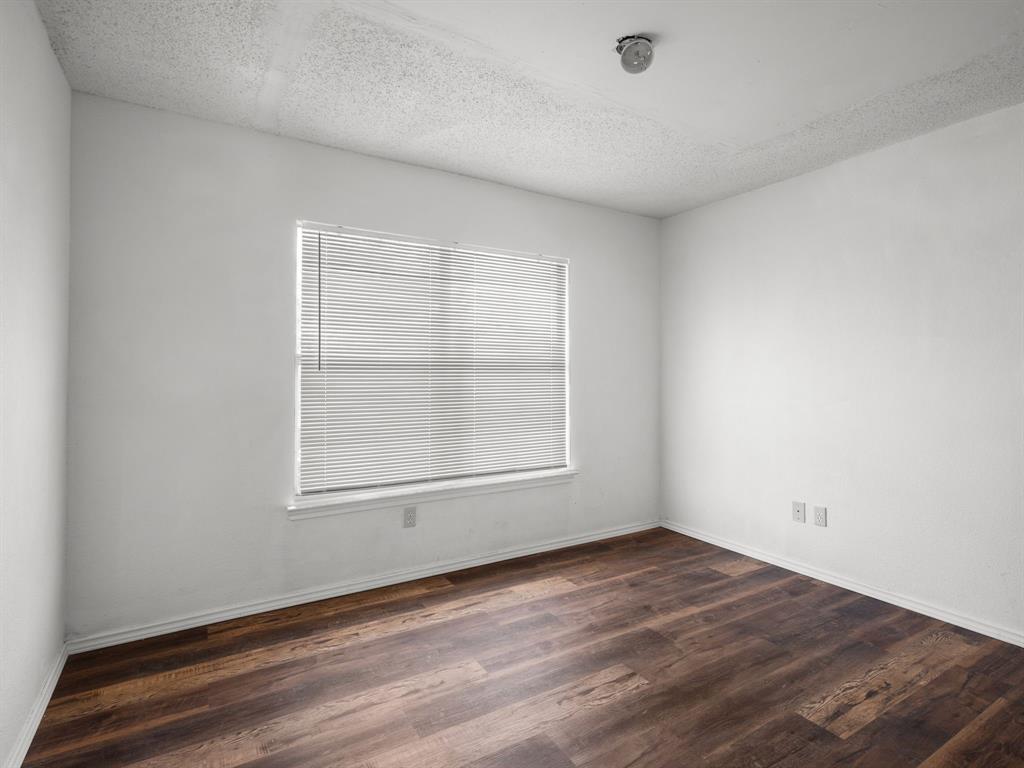 1237 McCary Street Cedar Hill, TX 75104 - Photo 27 of 38 an empty room with wooden floor and windows