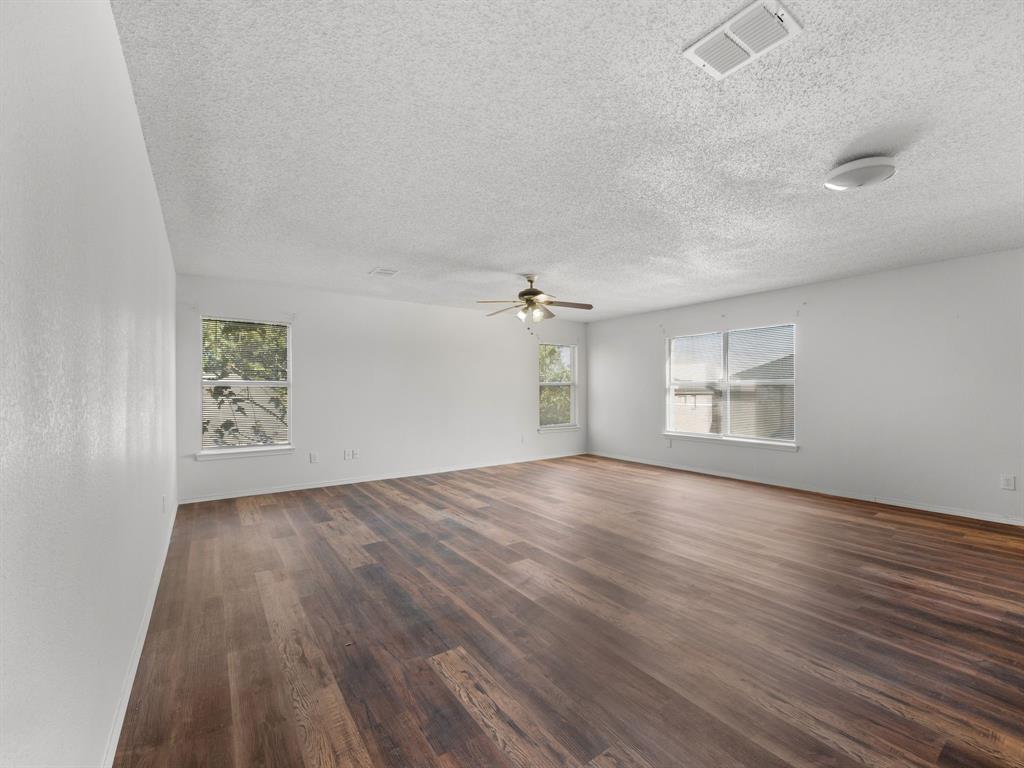1237 McCary Street Cedar Hill, TX 75104 - Photo 29 of 38 an empty room with wooden floor cabinet and windows
