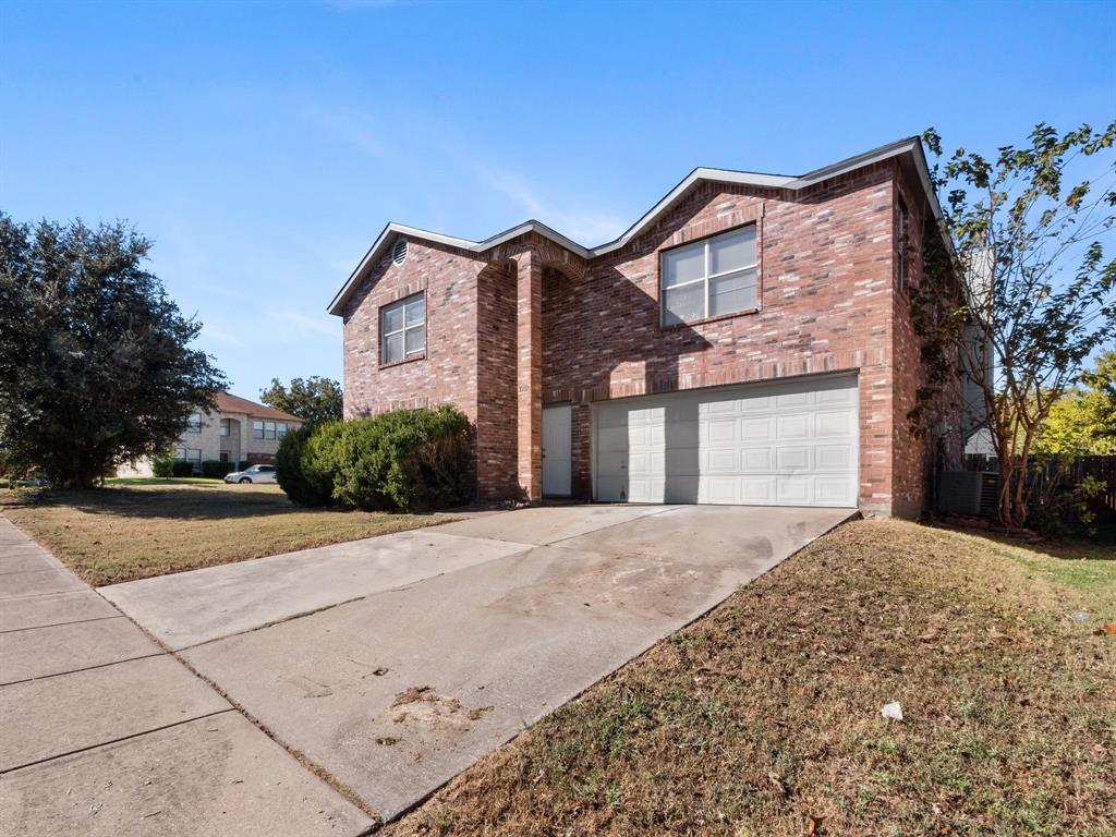1237 McCary Street Cedar Hill, TX 75104 - Photo 3 of 38 a front view of a house with a yard and garage