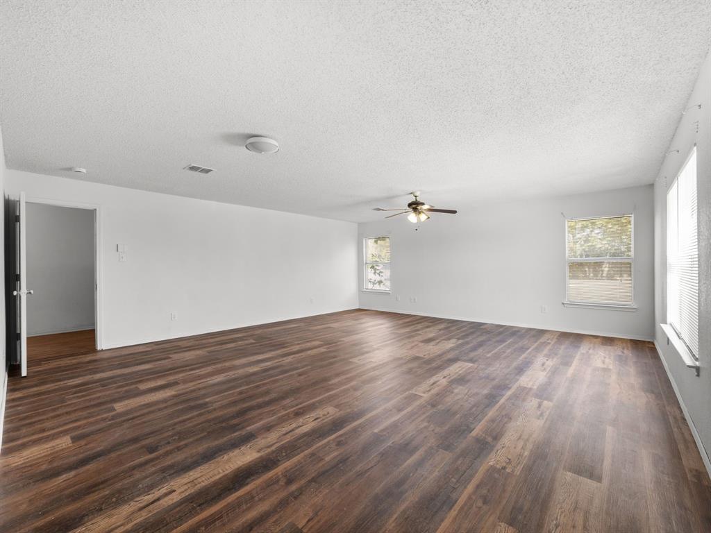 1237 McCary Street Cedar Hill, TX 75104 - Photo 32 of 38 an empty room with wooden floor and windows