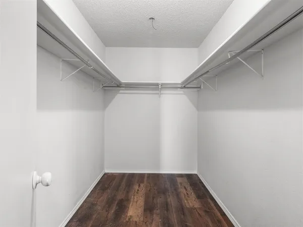 a view of a room with wooden floor