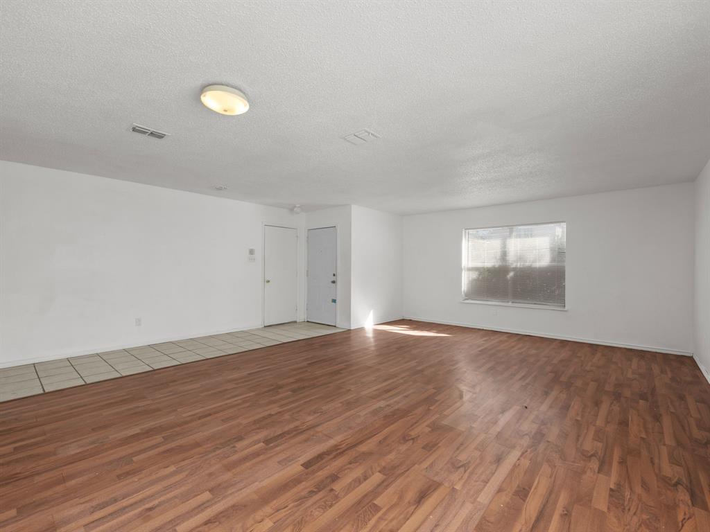 1237 McCary Street Cedar Hill, TX 75104 - Photo 7 of 38 an empty room with wooden floor and windows