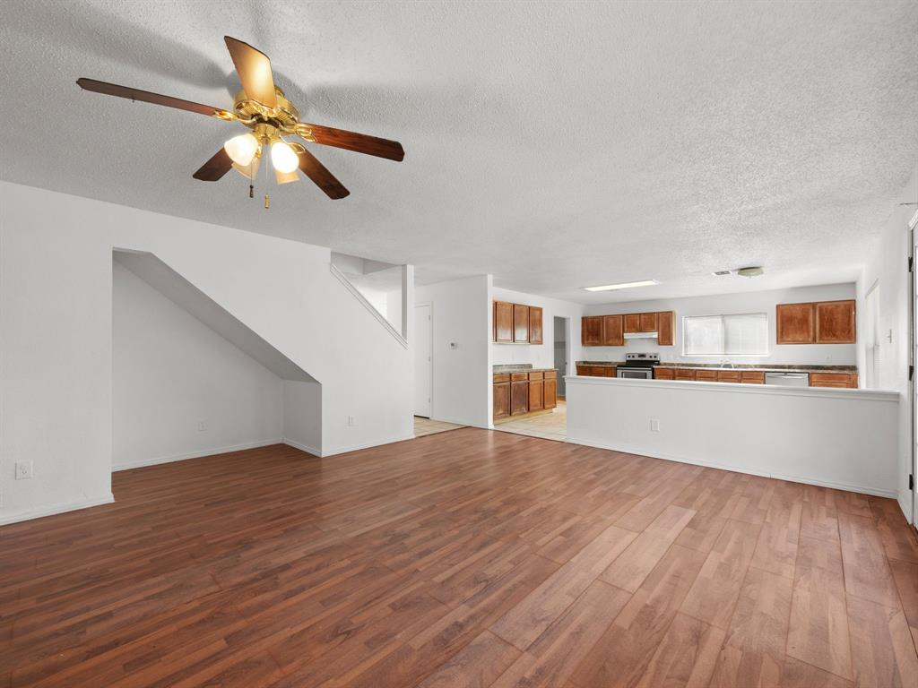 1237 McCary Street Cedar Hill, TX 75104 - Photo 10 of 38 a view of a livingroom with wooden floor and a ceiling fan