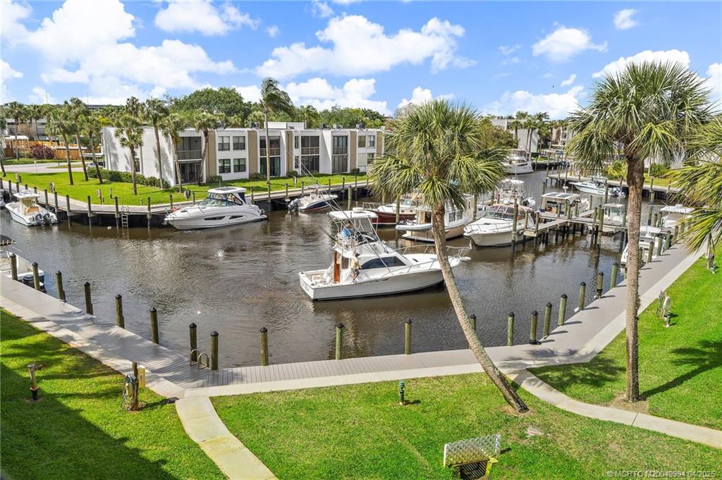 1950 Southwest Palm City Road, Unit 5310 Stuart, FL 34994 - Photo 1 of 72 a view of a lake with a house swimming pool and outdoor space