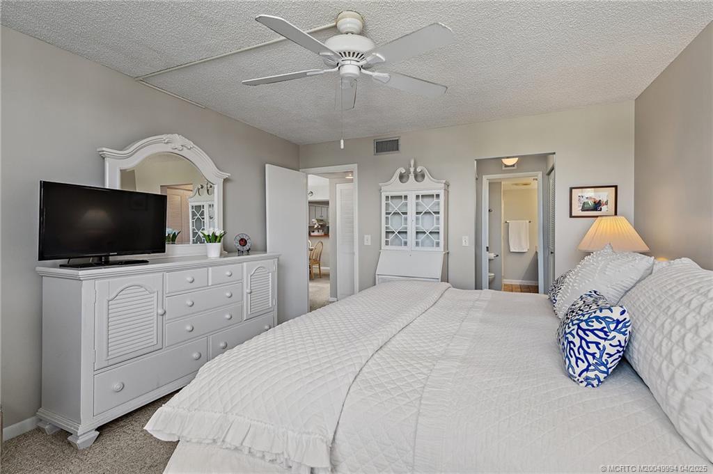 1950 Southwest Palm City Road, Unit 5310 Stuart, FL 34994 - Photo 14 of 72 a bedroom with a bed and a flat screen tv