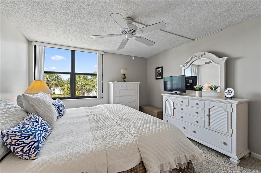 1950 Southwest Palm City Road, Unit 5310 Stuart, FL 34994 - Photo 15 of 72 a bedroom with a large bed and a window