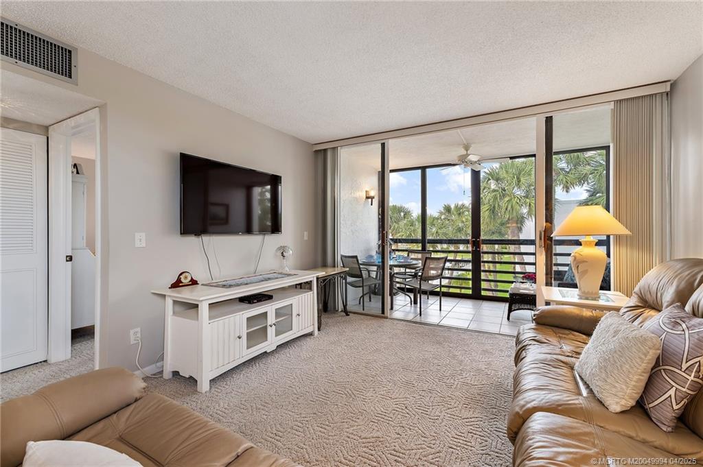 1950 Southwest Palm City Road, Unit 5310 Stuart, FL 34994 - Photo 18 of 72 a living room with furniture and a flat screen tv