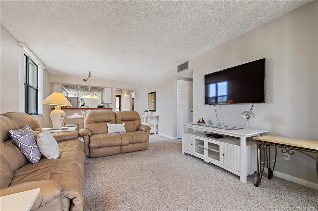 1950 Southwest Palm City Road, Unit 5310 Stuart, FL 34994 - Photo 19 of 72 a living room with furniture and a flat screen tv