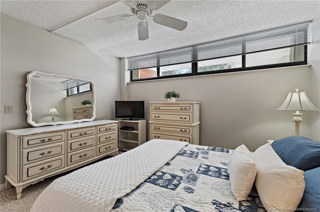 1950 Southwest Palm City Road, Unit 5310 Stuart, FL 34994 - Photo 24 of 72 a bedroom with a bed and cabinets