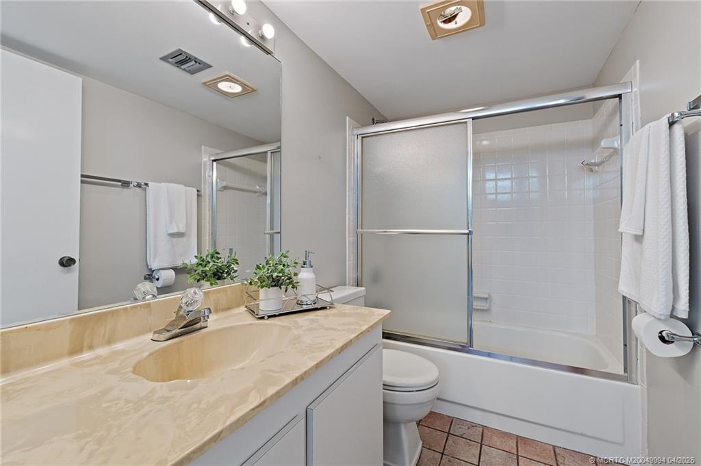1950 Southwest Palm City Road, Unit 5310 Stuart, FL 34994 - Photo 25 of 72 a bathroom with a granite countertop sink toilet and shower