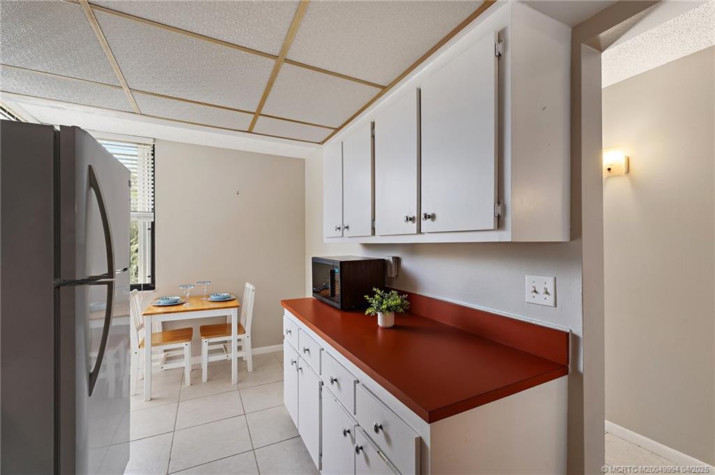 1950 Southwest Palm City Road, Unit 5310 Stuart, FL 34994 - Photo 29 of 72 a kitchen with stainless steel appliances granite countertop a sink refrigerator and cabinets