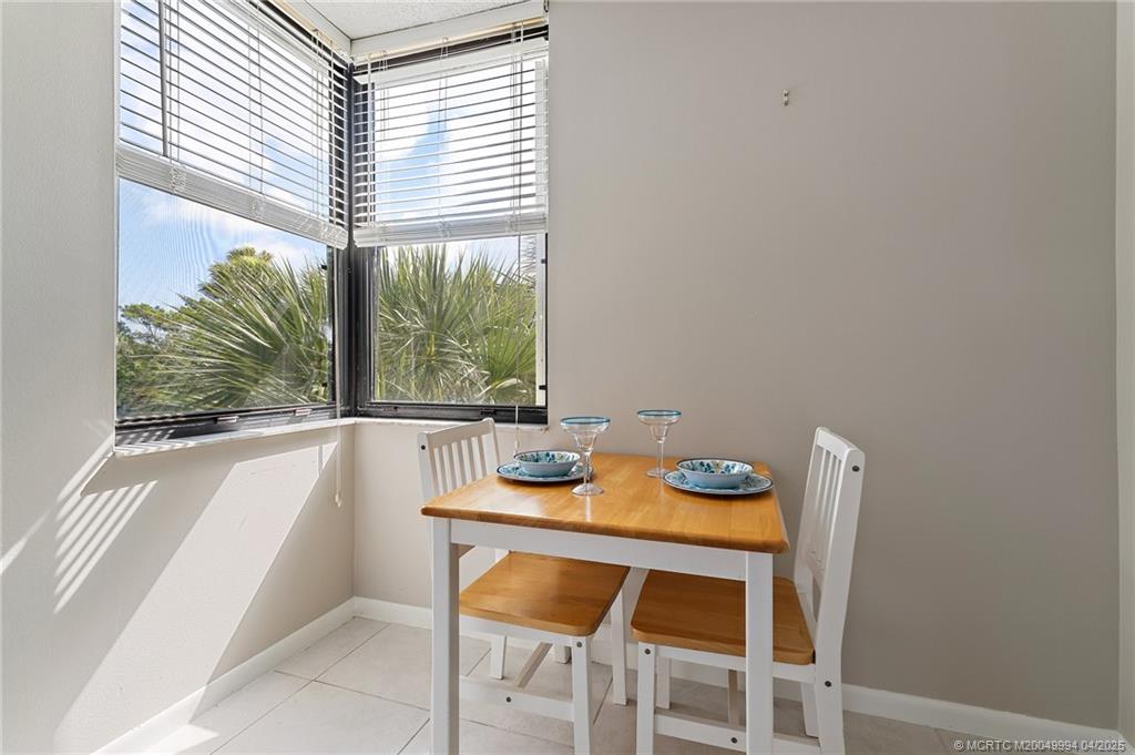 1950 Southwest Palm City Road, Unit 5310 Stuart, FL 34994 - Photo 30 of 72 a dining room with furniture and window