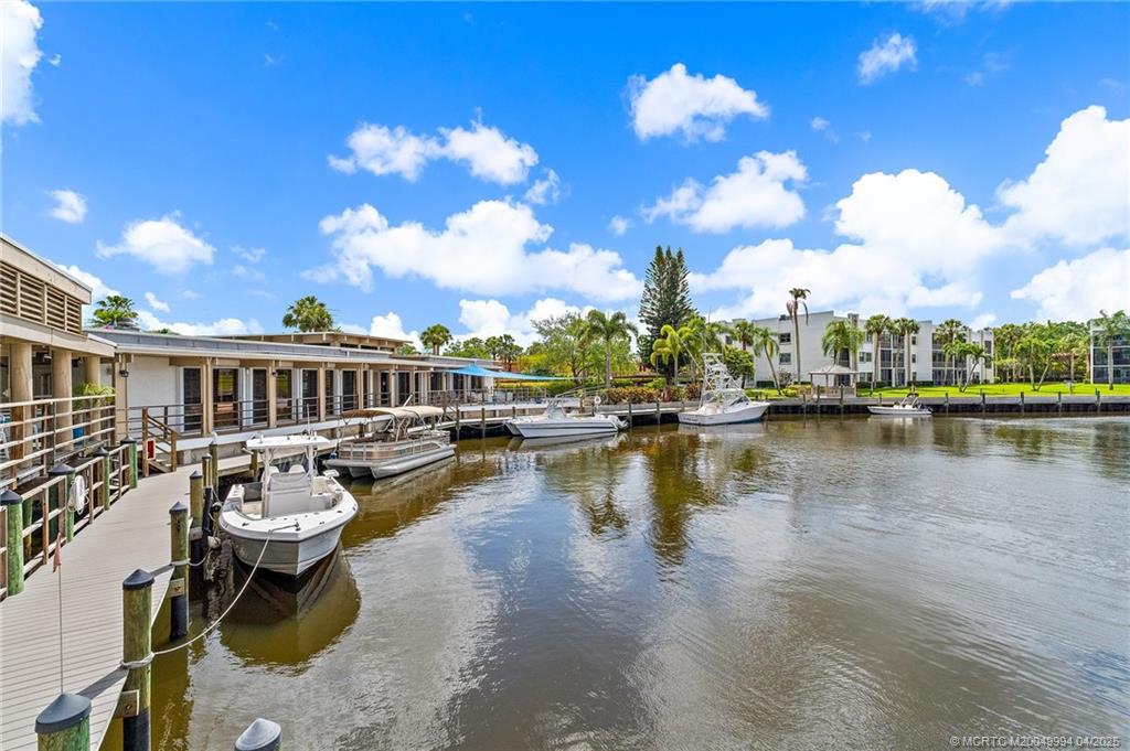 1950 Southwest Palm City Road, Unit 5310 Stuart, FL 34994 - Photo 33 of 72 a view of a lake with a house swimming pool and outdoor space