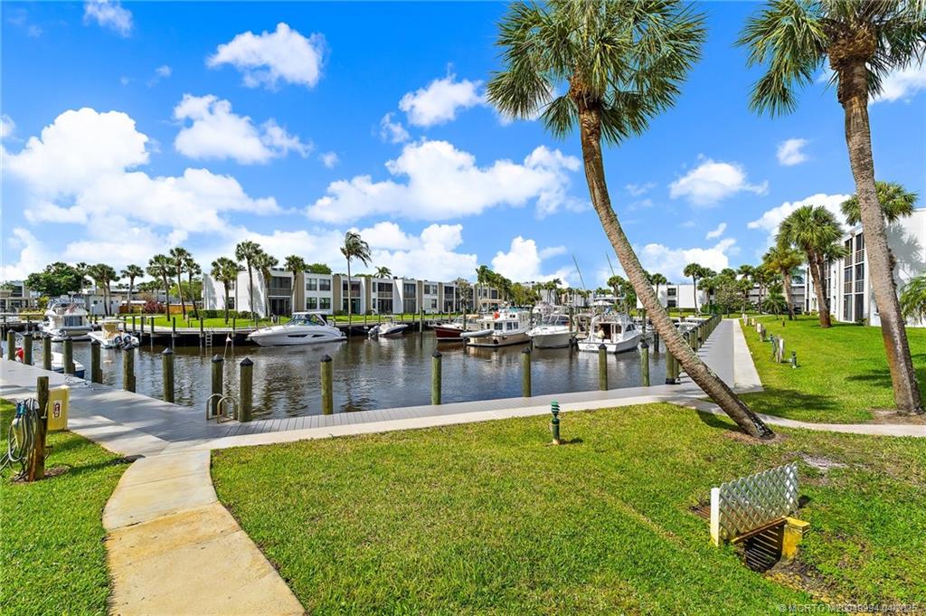 1950 Southwest Palm City Road, Unit 5310 Stuart, FL 34994 - Photo 40 of 72 a swimming pool with outdoor seating and lake