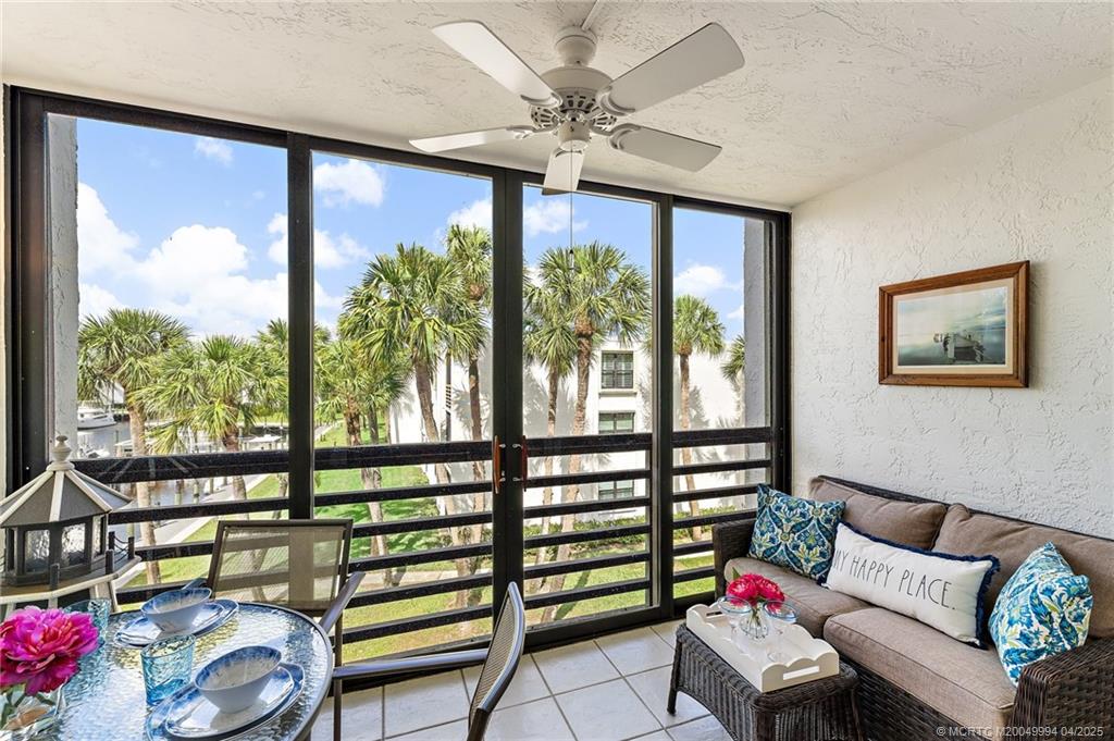 1950 Southwest Palm City Road, Unit 5310 Stuart, FL 34994 - Photo 4 of 72 a living room with furniture and a large window