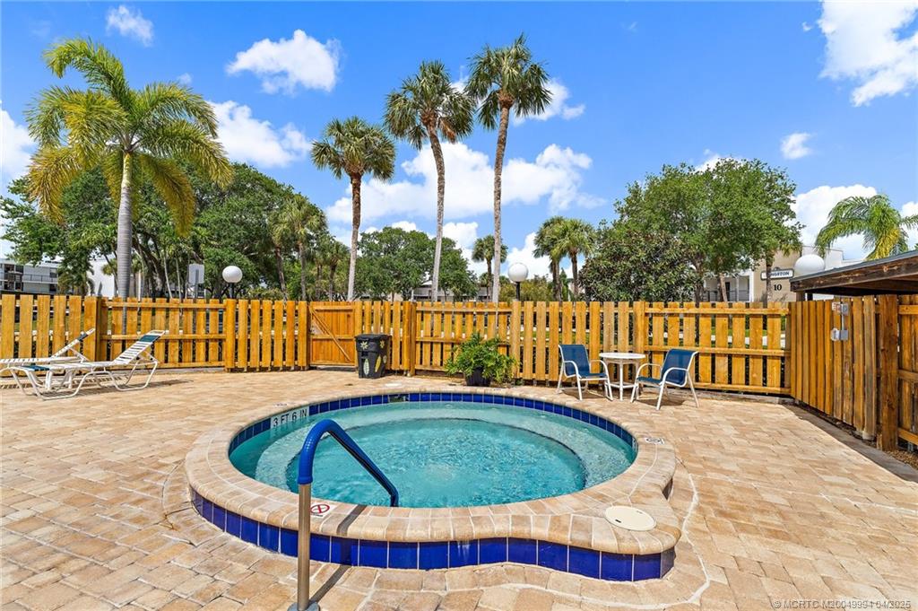 1950 Southwest Palm City Road, Unit 5310 Stuart, FL 34994 - Photo 45 of 72 a view of a swimming pool with a lounge chairs