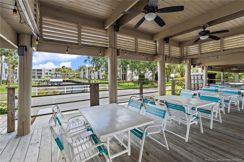1950 Southwest Palm City Road, Unit 5310 Stuart, FL 34994 - Photo 47 of 72 a view of a patio with a table and chairs