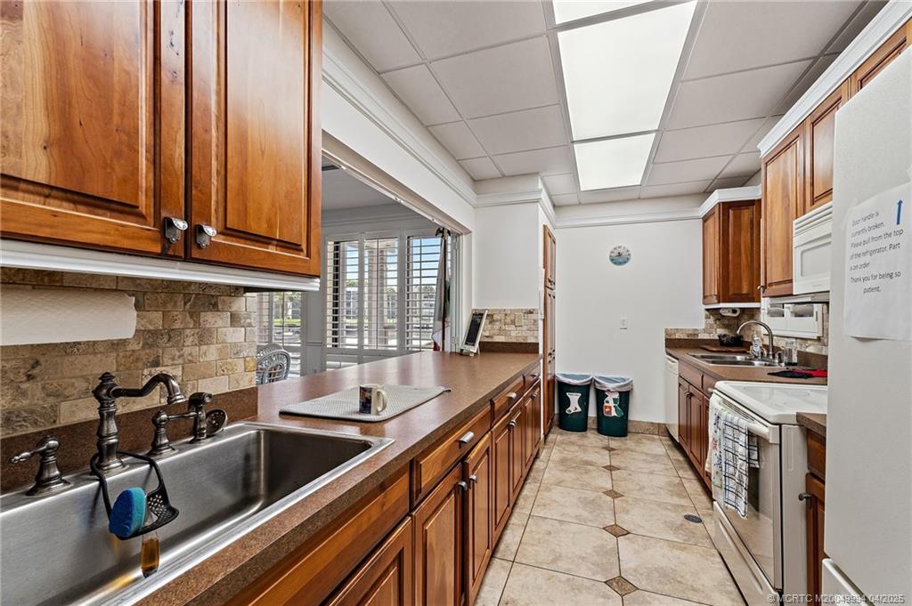 1950 Southwest Palm City Road, Unit 5310 Stuart, FL 34994 - Photo 52 of 72 a kitchen with stainless steel appliances granite countertop a sink and cabinets