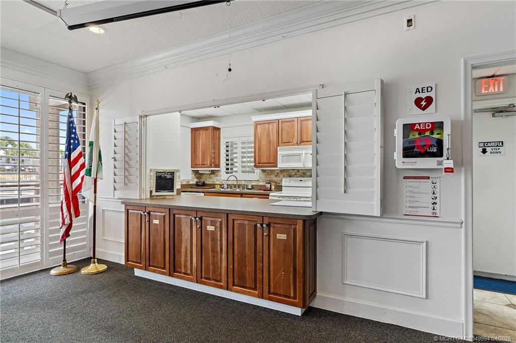 1950 Southwest Palm City Road, Unit 5310 Stuart, FL 34994 - Photo 53 of 72 a kitchen with stainless steel appliances granite countertop a sink and cabinets