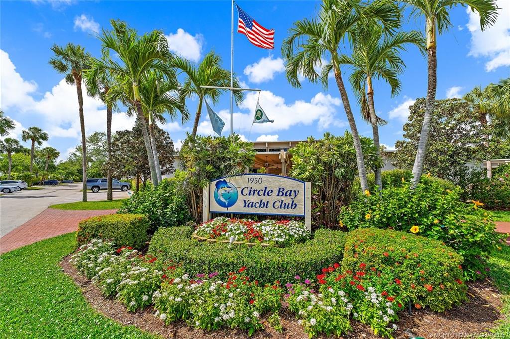 1950 Southwest Palm City Road, Unit 5310 Stuart, FL 34994 - Photo 7 of 72 a sign that is in front of flowers