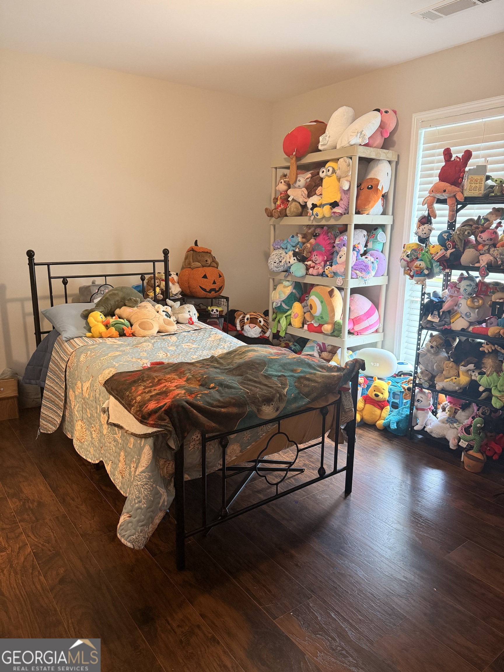 892 Perimeter Road Monticello, GA 31064 - Photo 27 of 38 a bedroom with a bed and wooden floor