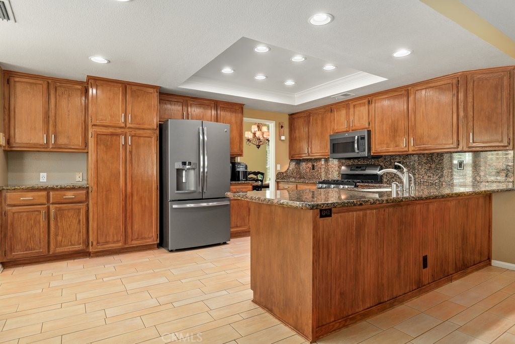 7910 Westgate Court Riverside, CA 92506 - Photo 11 of 61 a kitchen with stainless steel appliances granite countertop a refrigerator sink and microwave