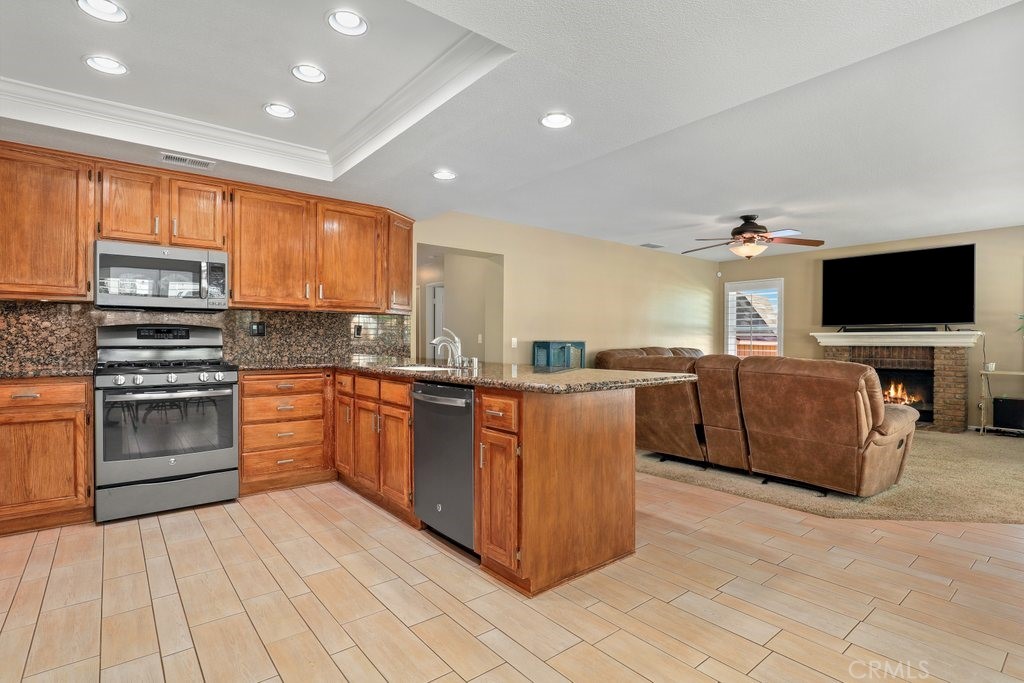 7910 Westgate Court Riverside, CA 92506 - Photo 12 of 61 a large kitchen with stainless steel appliances granite countertop a stove and a sink
