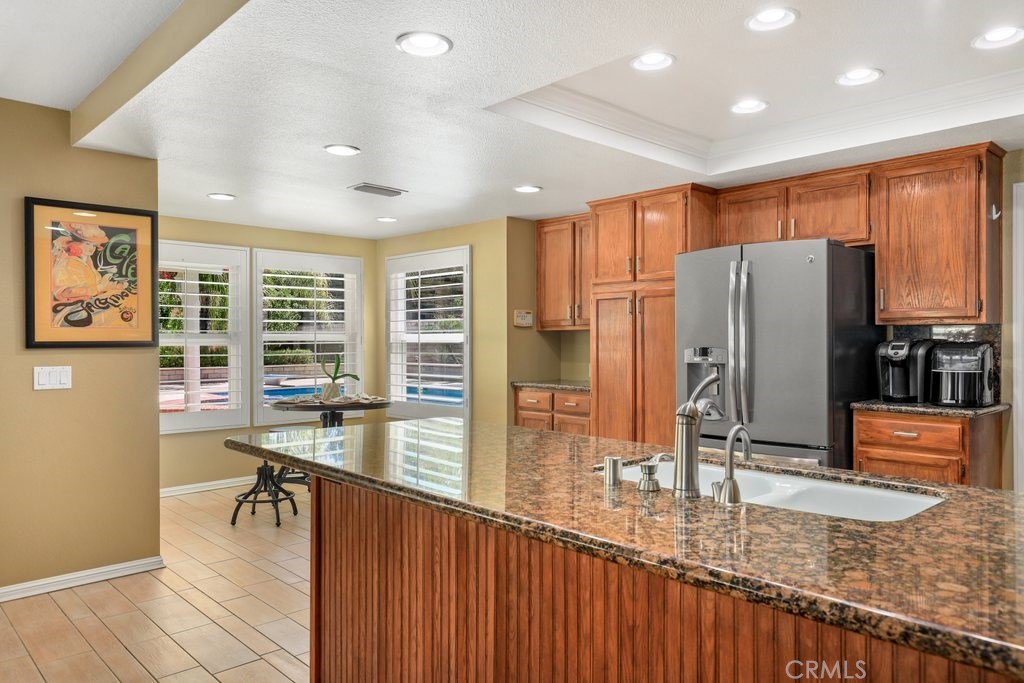 7910 Westgate Court Riverside, CA 92506 - Photo 14 of 61 a kitchen with stainless steel appliances granite countertop a refrigerator and a sink