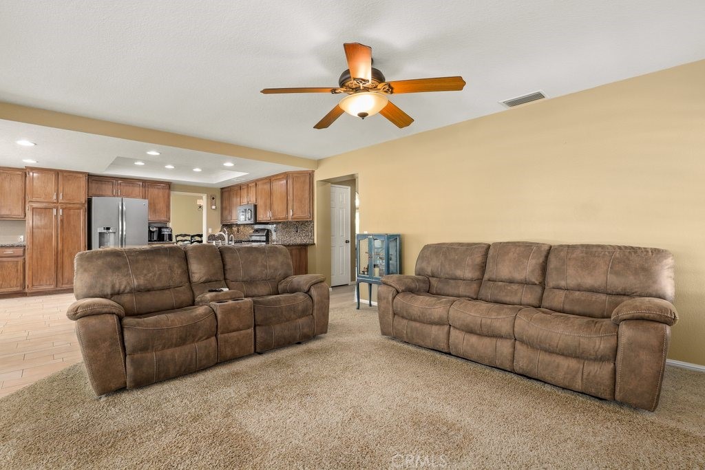 7910 Westgate Court Riverside, CA 92506 - Photo 18 of 61 a living room with furniture and a ceiling fan