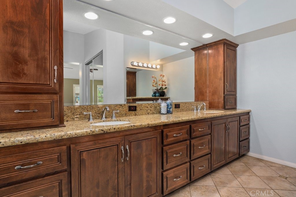 7910 Westgate Court Riverside, CA 92506 - Photo 28 of 61 a bathroom with a granite countertop sink double and mirror