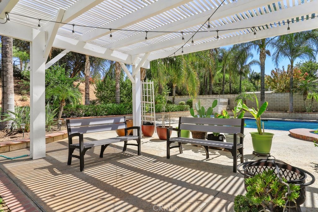 7910 Westgate Court Riverside, CA 92506 - Photo 40 of 61 a view of a patio with dining table and chairs with wooden floor and fence