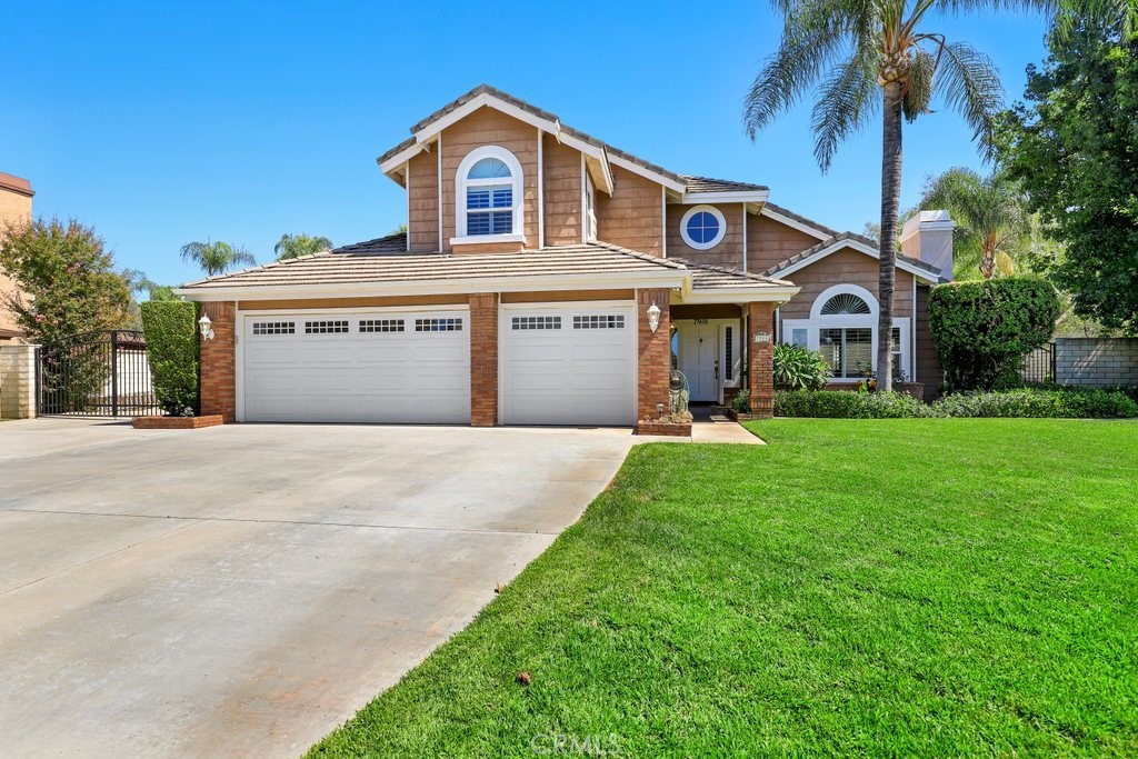 7910 Westgate Court Riverside, CA 92506 - Photo 4 of 61 a front view of a house with a yard and garage
