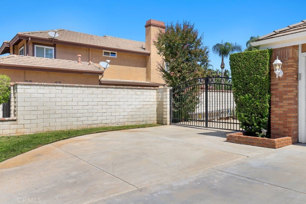 7910 Westgate Court Riverside, CA 92506 - Photo 5 of 61 a front view of a house with a yard and garage