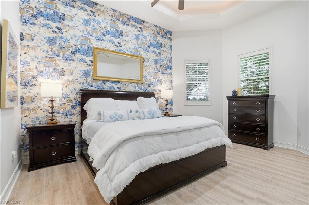 7840 Valencia Court Naples, FL 34113 - Photo 12 of 24 Bedroom with light wood finished floors, wallpapered walls, ceiling fan, and crown molding