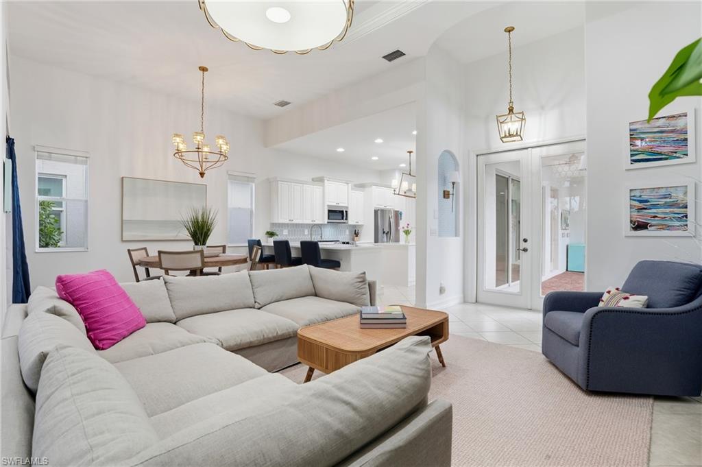 7840 Valencia Court Naples, FL 34113 - Photo 2 of 24 Living room featuring light tile patterned floors, recessed lighting, and a chandelier