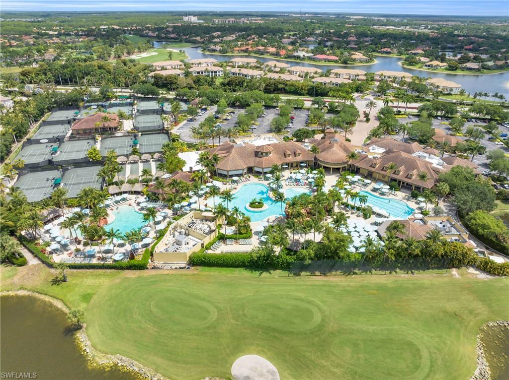 7840 Valencia Court Naples, FL 34113 - Photo 23 of 24 Aerial view of property and surrounding area featuring a large body of water and nearby suburban area