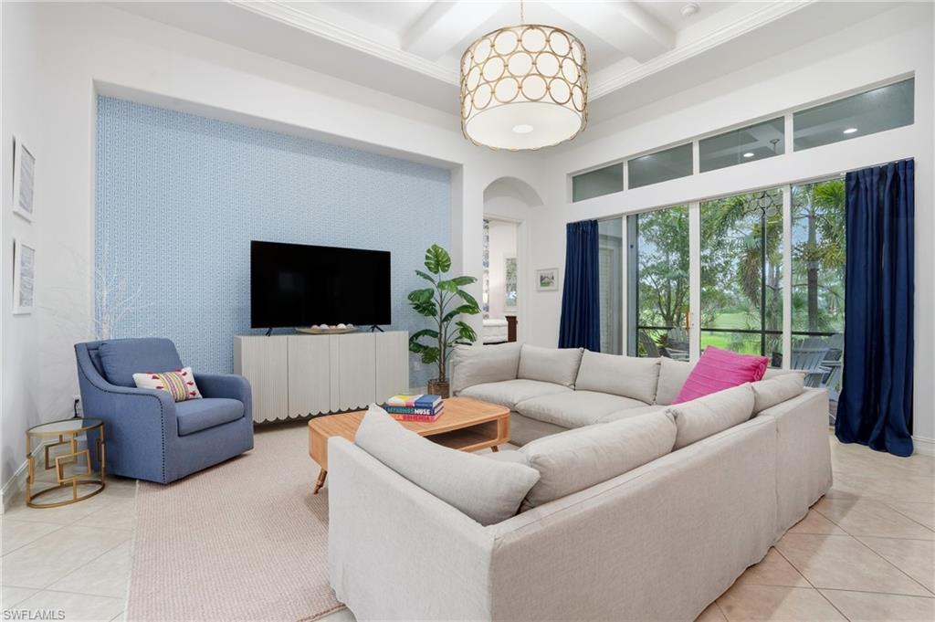 7840 Valencia Court Naples, FL 34113 - Photo 3 of 24 Living area featuring light tile patterned floors, arched walkways, coffered ceiling, beamed ceiling, and a towering ceiling