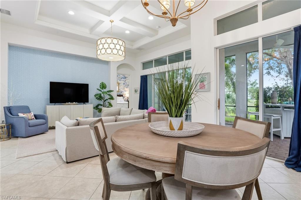 7840 Valencia Court Naples, FL 34113 - Photo 5 of 24 Dining space with coffered ceiling, beam ceiling, a high ceiling, arched walkways, and light tile patterned floors