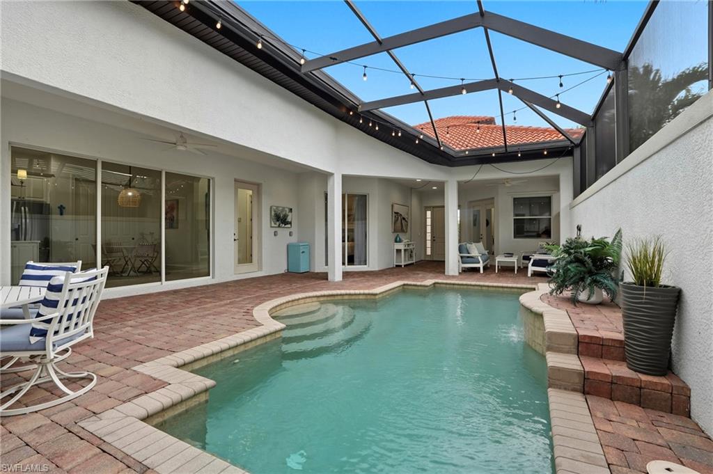 7840 Valencia Court Naples, FL 34113 - Photo 9 of 24 Back of house with stucco siding, ceiling fan, a patio, and an outdoor pool