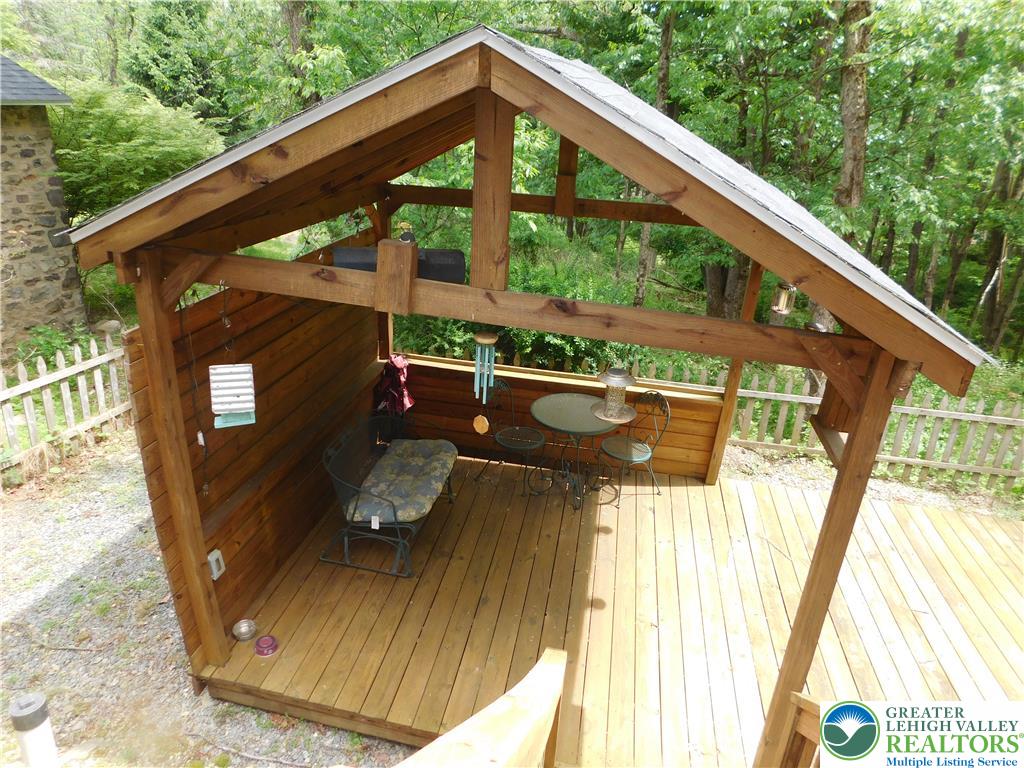 41 Reeder Street Mount Pocono, PA 18344 - Photo 10 of 41 A private, covered deck provides a peaceful retreat surrounded by mature trees.