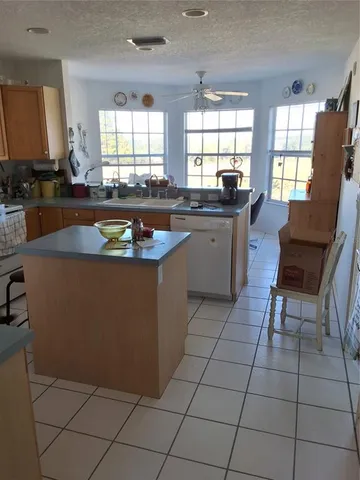a kitchen with granite countertop a sink a counter top space and appliances