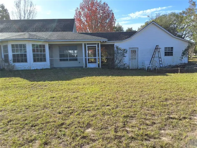 a house that has a large pool in front of it