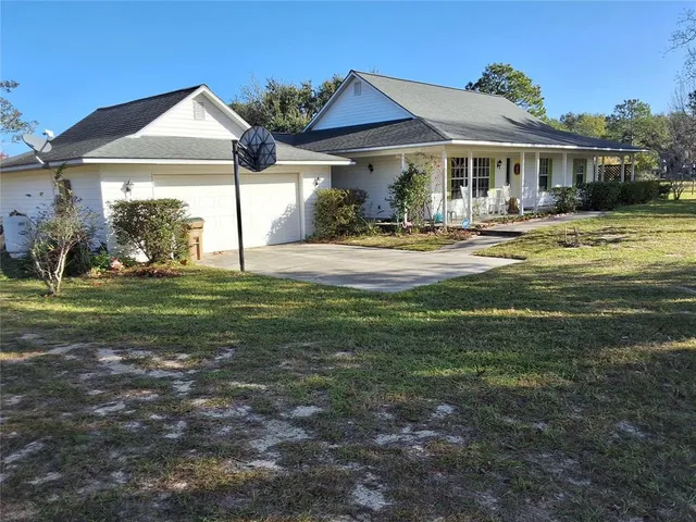 a front view of a house with swimming pool having outdoor seating