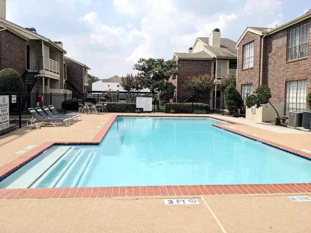 a view of a swimming pool with a patio