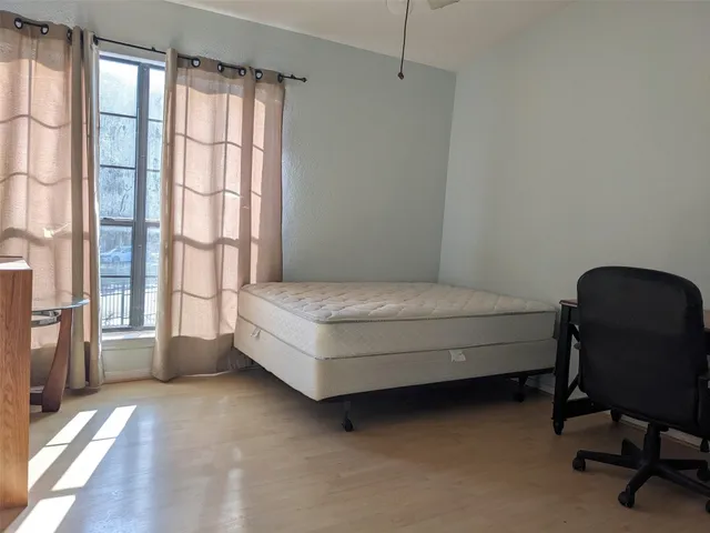 a room with a bed chair and a window