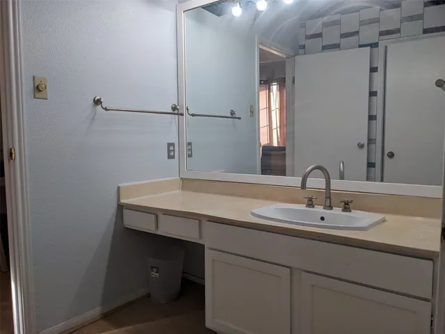 a bathroom with a sink and a mirror