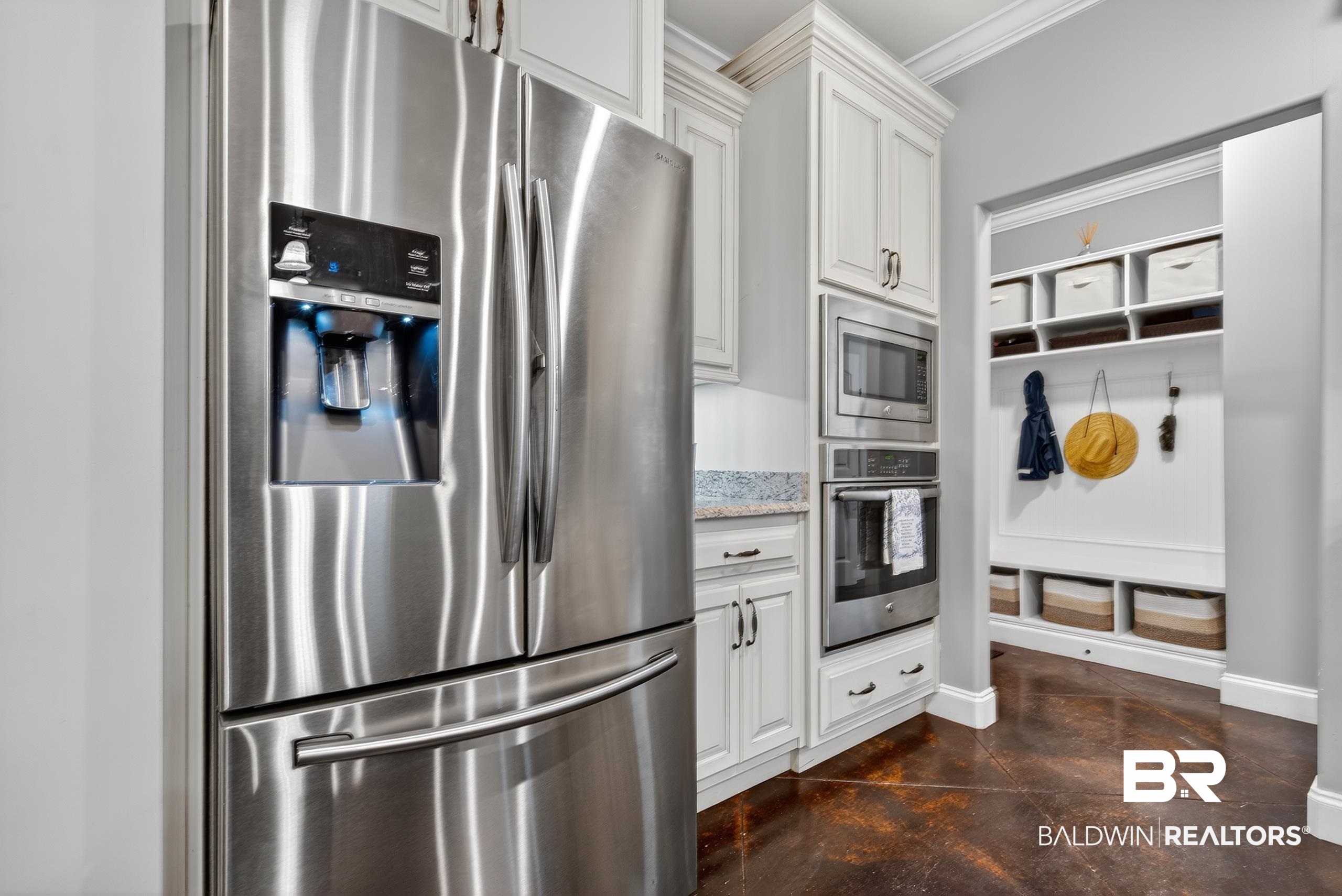 5517 Rabbit Creek Drive Theodore, AL 36582 - Photo 6 of 33 Kitchen with stainless steel appliances, white cabinets, concrete floors, light stone counters, and ornamental molding