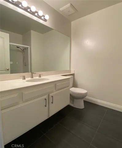 a bathroom with a double vanity sink and a toilet